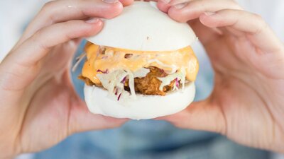 Hands holding a bao