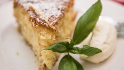 Plate with piece of cake and cream