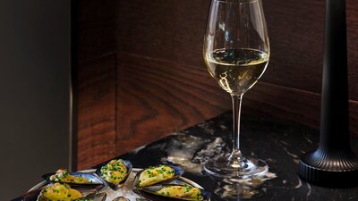 White wine and oysters presented on a table