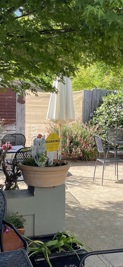 Courtyard with tables and chairs at Merino Café, Gunning.