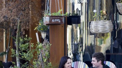 Couple drinking coffee outdoors