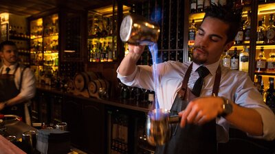 Bartender making flaming cocktails