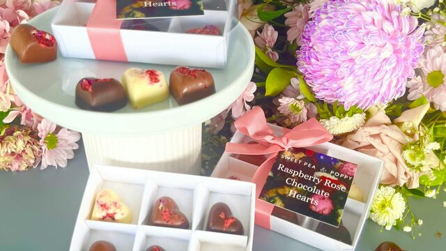 Sweet Pea & Poppy gift boxed artisan chocolate hearts gift boxed artisan chocolate hearts With individual artisan chocolate hearts, flowers in backhround