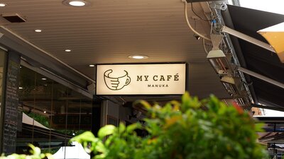Backlit sign saying 'My Cafe Manuka'