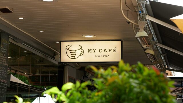 Backlit sign saying 'My Cafe Manuka'