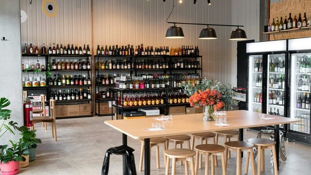 Store layout of Paranormal Wines - stools, tables and variety of wines