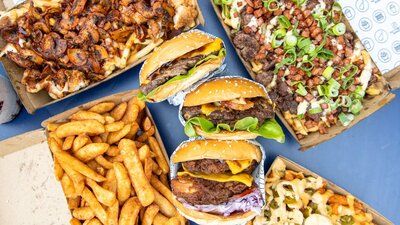 Burgers, fries and drink on a table