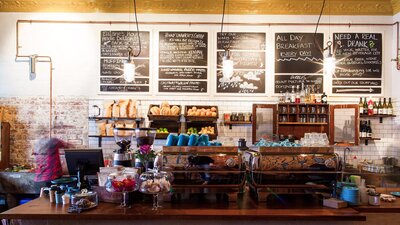Cafe counter with fresh bread and blackboard menus
