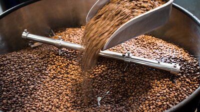 Coffee beans in a large grinder