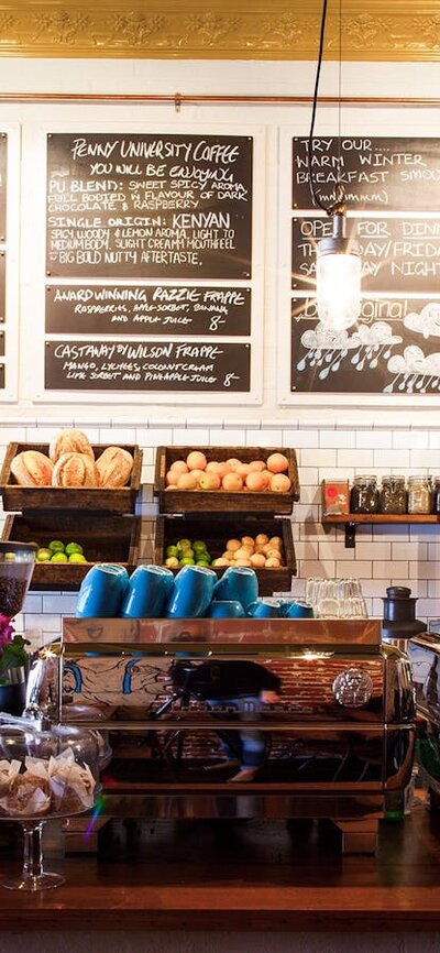 Cafe counter with fresh bread and blackboard menus