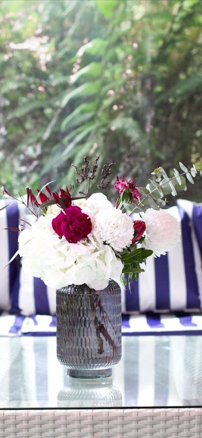 Fresh blue and white furniture by a window overlooking the rainforest garden