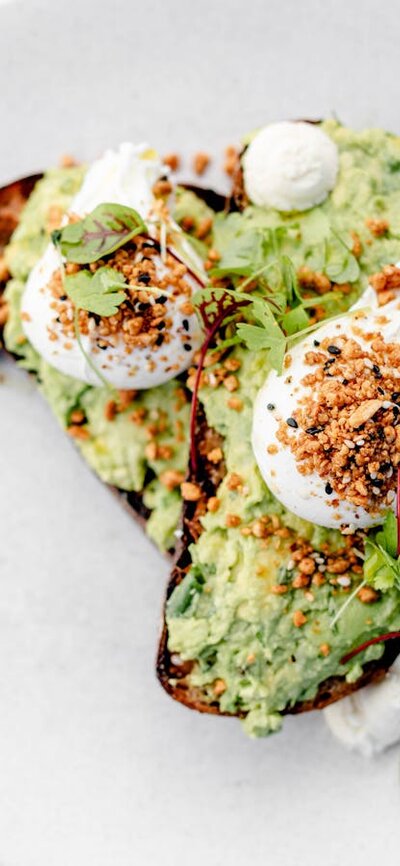 Smashed avocado & goats curd w/ poached eggs & dukkha on grilled rye toast (v, gf*, df*)