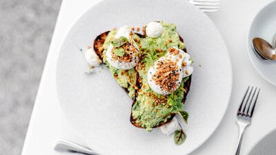 Smashed avocado & goats curd w/ poached eggs & dukkha on grilled rye toast (v, gf*, df*)