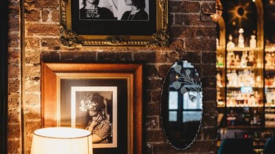 Brick wall with portraits in dining area
