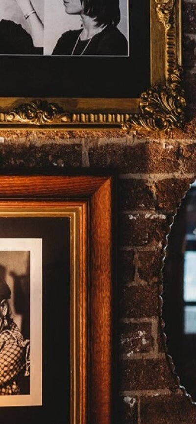 Brick wall with portraits in dining area