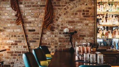 Bar stools and brown flags decorating back wall