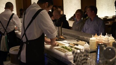 Chefs cooking at bar