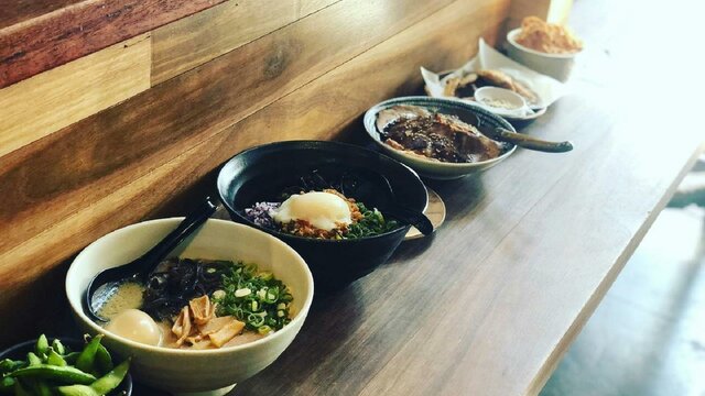Bowls of ramen on long table