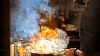 Head Chef, Federico Pitasi working over the grill in the kitchen