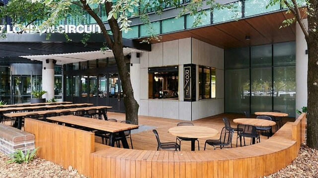 Outdoor cafe setting with wooden furniture