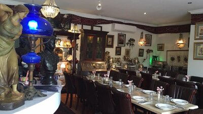 Empty restaurant setting with cutlery and crockery laid out on table