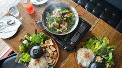 Asian dishes steaming laid out on a table