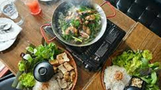 Asian dishes steaming laid out on a table
