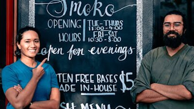 Owner and sister (Kavita) with outdoor hand painted signage