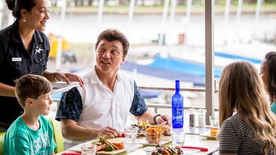 Family enjoying a meal overlooking the lake