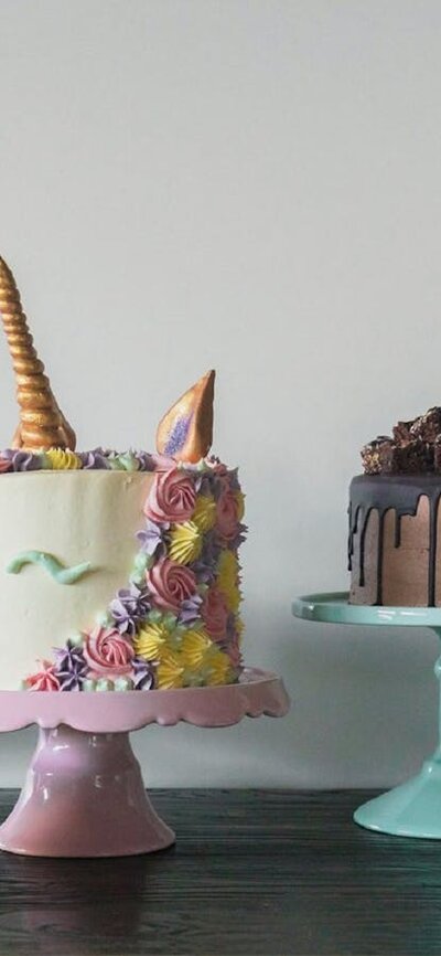 Line of decorated cakes of all colours and shapes.