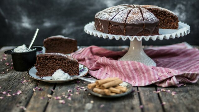 Chipotle Chocolate Cake Chipotle Chocolate Cake on a stand and a few slices on plates.