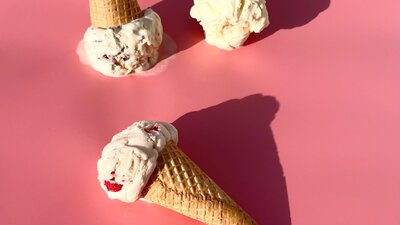 There’s ice-cream cones on a pink background