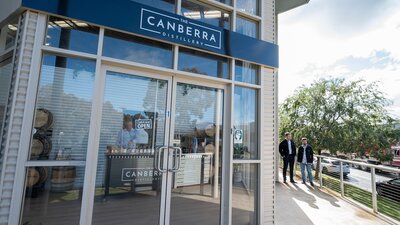 The Canberra Distillery shopfront with two men approaching