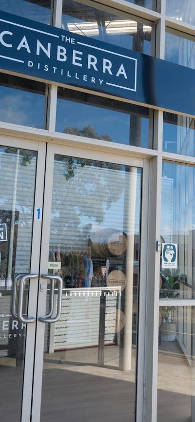 The Canberra Distillery shopfront with two men approaching