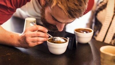Man inhaling the coffee aroma in his cup