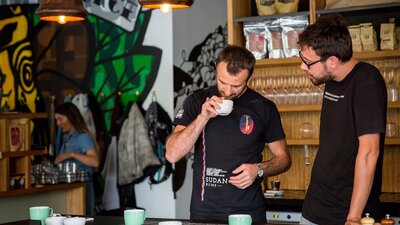 Two coffee experts smelling the coffee beans