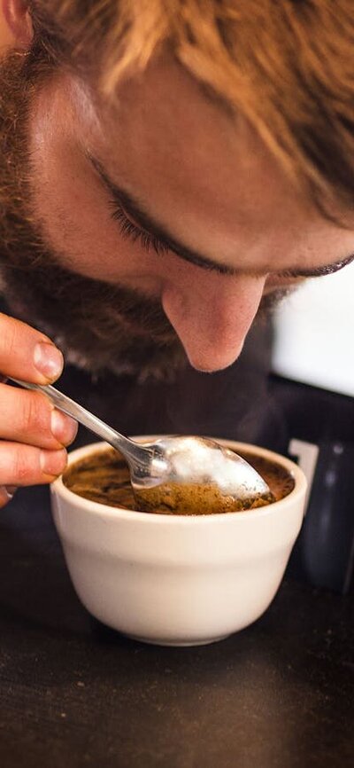 Man inhaling the coffee aroma in his cup