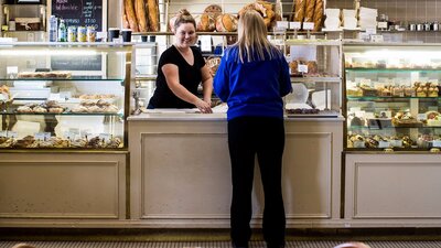 Lady being served at the bakery counter