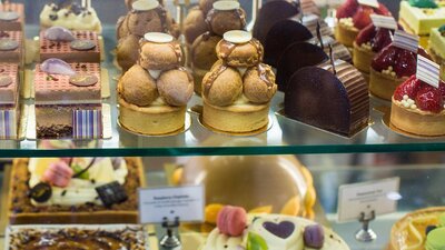 Display case of large and small cakes