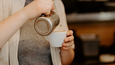 barista pouring coffee