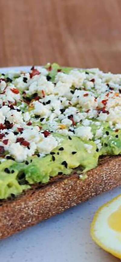 Avocado on toast with feta cheese and lemon