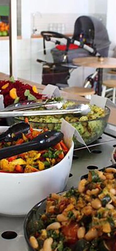 Bowls of salad on long counter