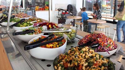 Bowls of salad on long counter