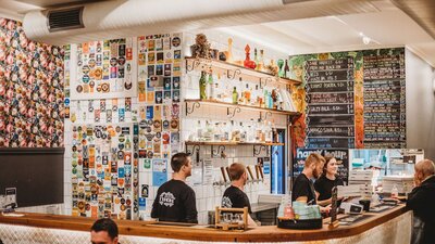 Group of people working behind a bar