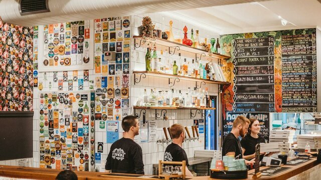 Group of people working behind a bar