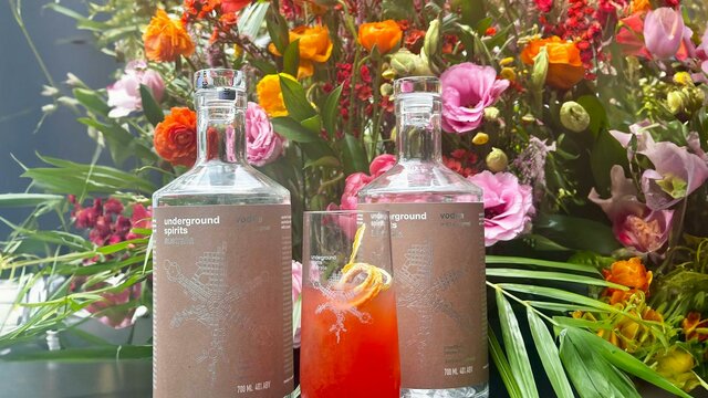 Underground Spirits Caramel Vodka Bottle of Underground Spirits Caramel Vodka surrounded by bright florals