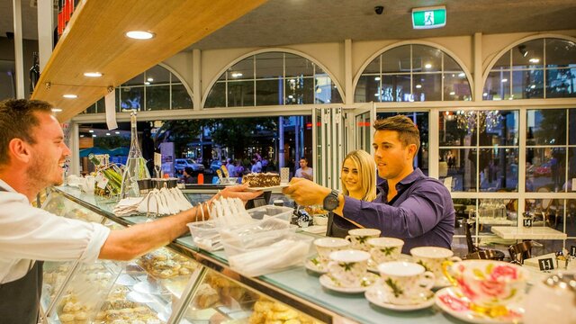 Fine Italian pastries and fine china Couple couple being served cake over the counter