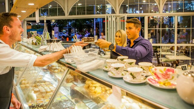 Fine Italian pastries and fine china Couple couple being served cake over the counter