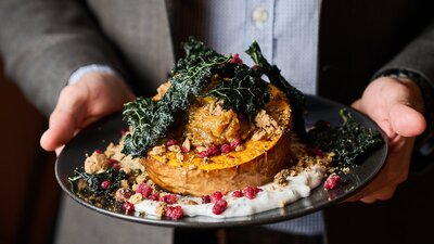 Person holding a main meal close up