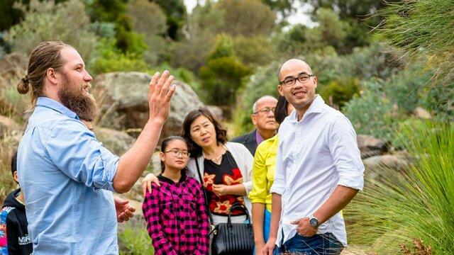 Learn about the world's largest collection of Australian Native Plans Garden's Ranger with international visitors